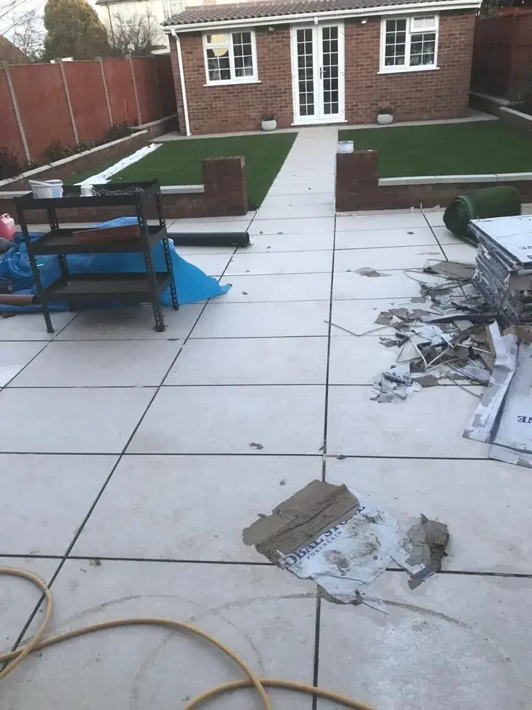 Back garden patio with paving slabs and landscaped borders