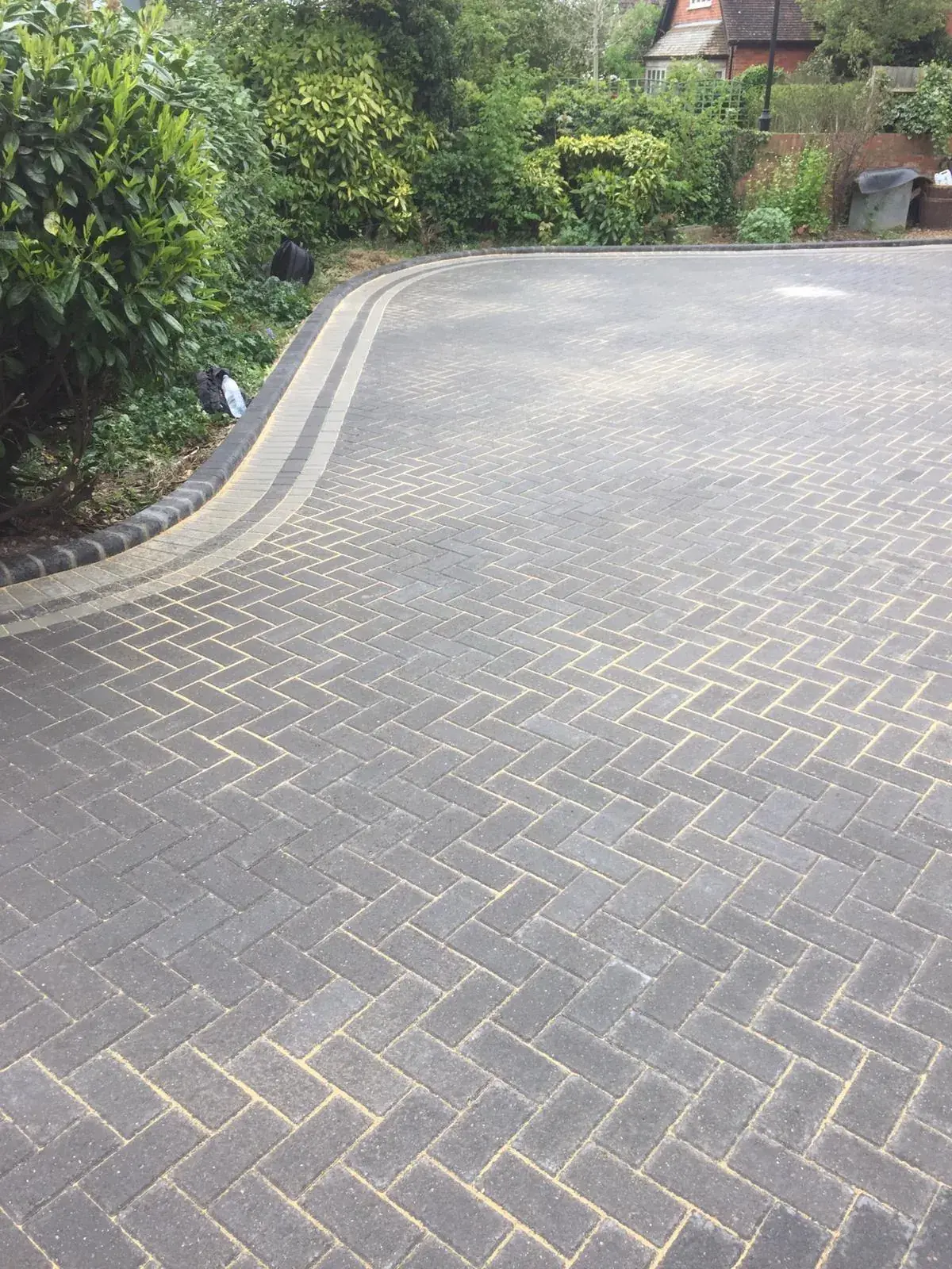 Close up of curved border work on block paved driveway