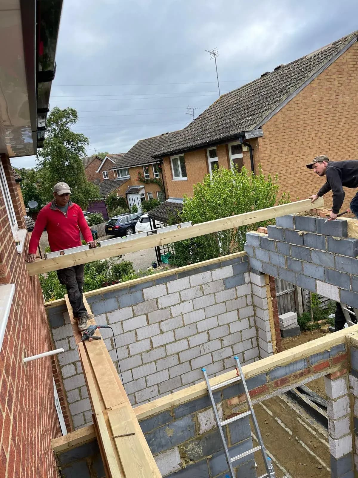 Wide view of extension brickwork meeting the existing roof line