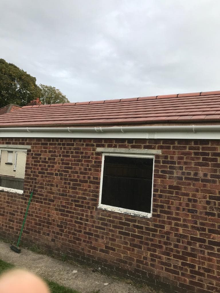 Roof tile completion and brick wall by BBBrotherBuilding in Hertfordshire